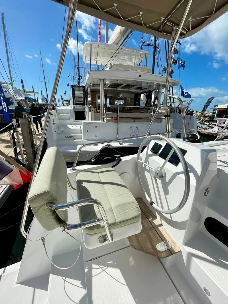 Slide: The Image of 2026 Bali CATSMART yacht helm with cushioned seat and steering wheel at marina. - 30