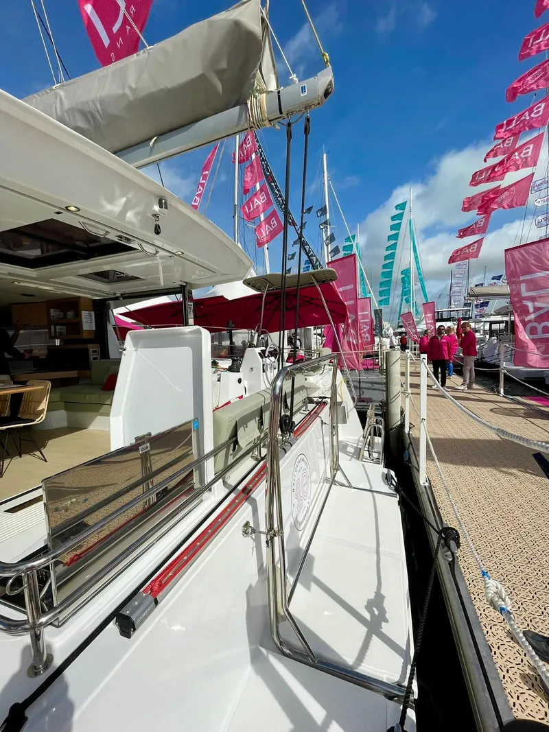 Slide: The Image of 2026 Bali CATSMART catamaran docked at marina with vibrant flags and clear blue sky. - 31