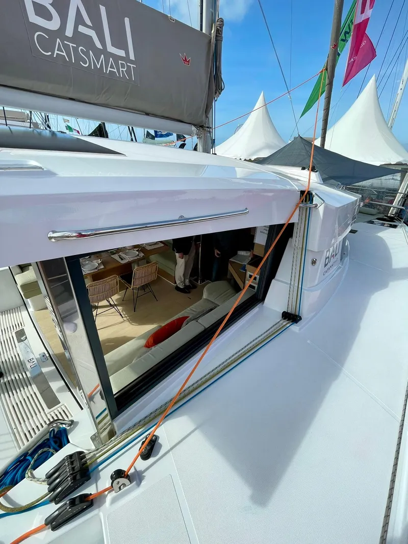 Slide: The Image of 2026 Bali CATSMART yacht with open deck and modern interior at a marina. - 32