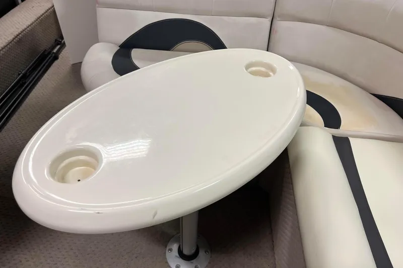 Slide: The Image of 2014 Avalon Grand Island 2485 QF boat interior with oval table and cushioned seating. - 20