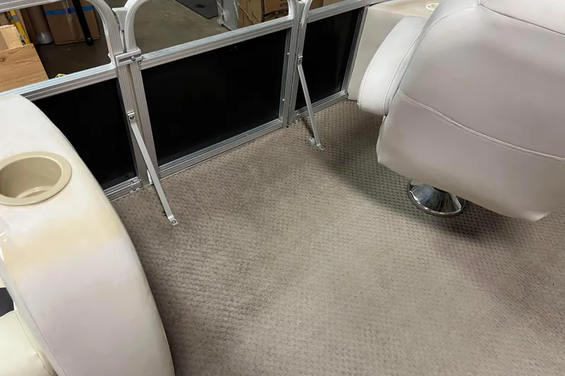 Slide: The Image of 2014 Avalon Grand Island 2485 QF interior with beige carpet and white seating. - 23
