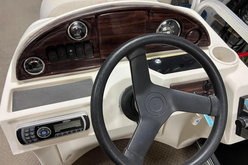 Slide: The Image of Steering console of 2014 Avalon Grand Island 2485 QF boat with controls and gauges. - 26