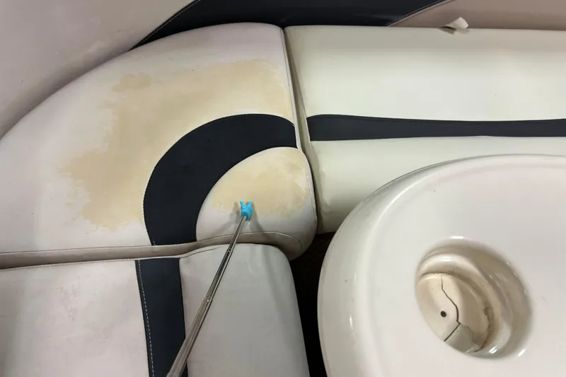 Slide: The Image of 2014 Avalon Grand Island 2485 QF boat interior with stained upholstery and cracked cup holder. - 36