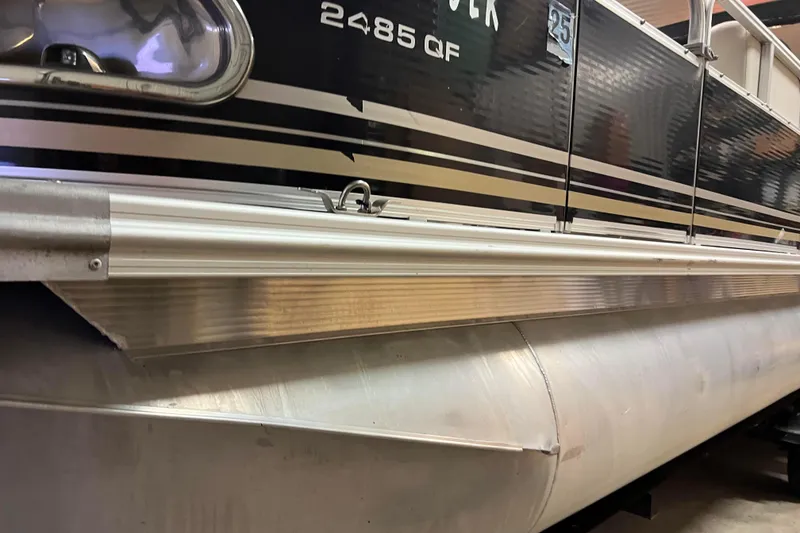 Slide: The Image of 2014 Avalon Grand Island 2485 QF pontoon boat side view with sleek design. - 4