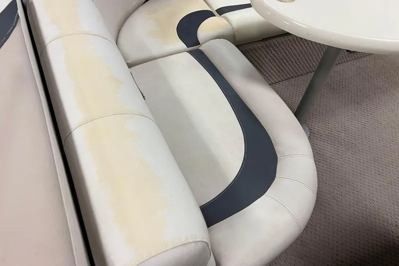 Slide: The Image of 2014 Avalon Grand Island 2485 QF boat seating with beige and navy upholstery. - 43