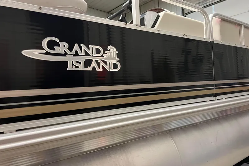 Slide: The Image of 2014 Avalon Grand Island 2485 QF pontoon boat with sleek black exterior design. - 45