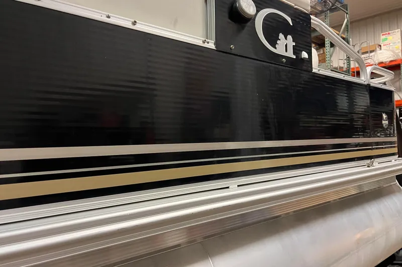 Slide: The Image of 2014 Avalon Grand Island 2485 QF pontoon boat with sleek black and silver design. - 47