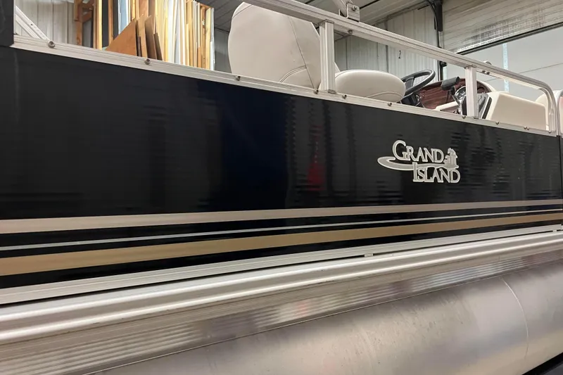 Slide: The Image of 2014 Avalon Grand Island 2485 QF pontoon boat side view in a garage. - 50