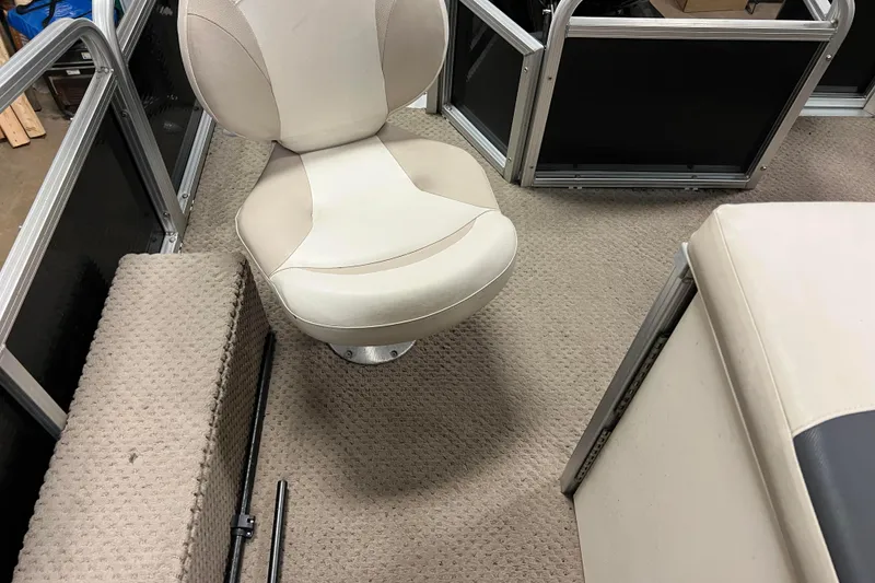 Slide: The Image of 2014 Avalon Grand Island 2485 QF boat interior with beige seating and carpeted flooring. - 56