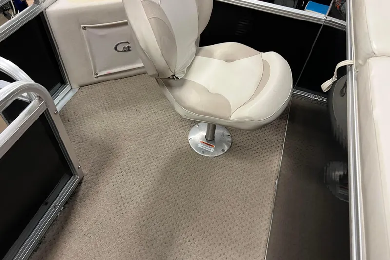 Slide: The Image of 2014 Avalon Grand Island 2485 QF boat interior with beige swivel seat and carpeted floor. - 60