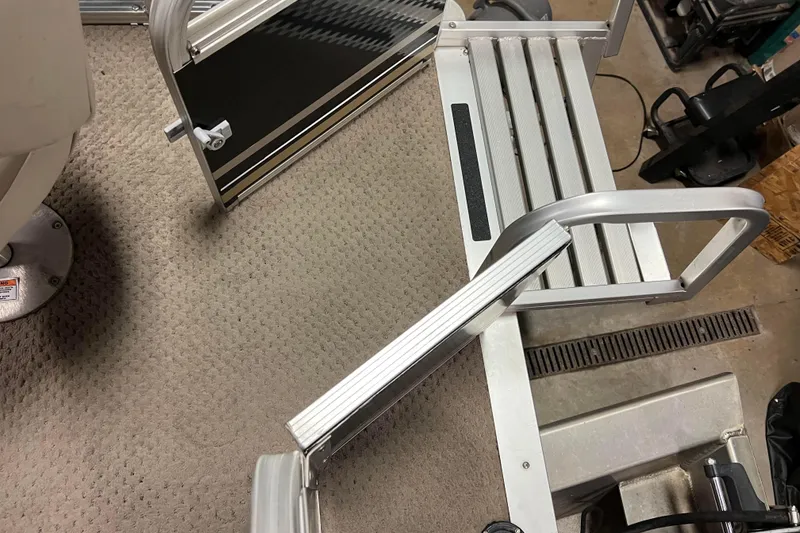 Slide: The Image of 2014 Avalon Grand Island 2485 QF boat interior with aluminum steps and carpeted flooring. - 65