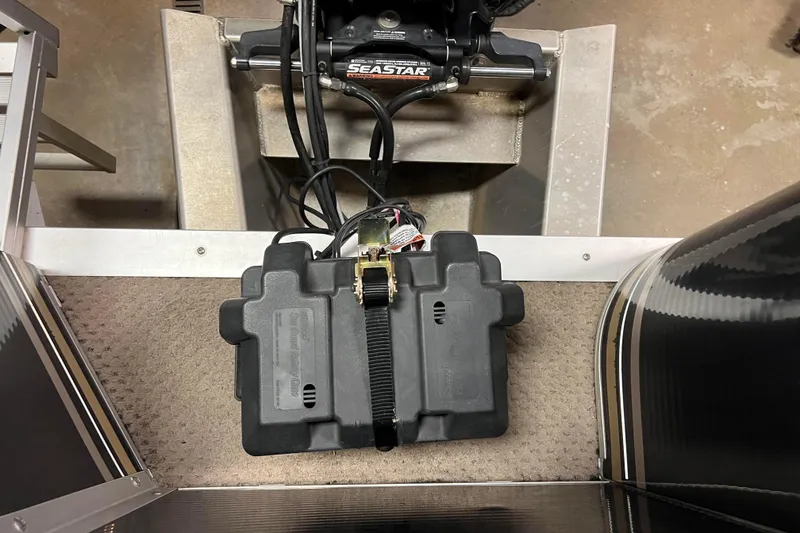 Slide: The Image of Battery compartment of 2014 Avalon Grand Island 2485 QF with SeaStar hydraulic steering. - 67