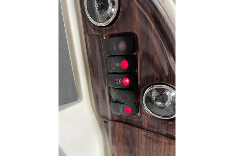 Slide: The Image of Control panel of 2014 Avalon Grand Island 2485 QF with switches and fuel gauge. - 72