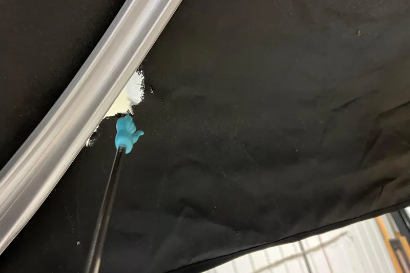 Slide: The Image of Close-up of Avalon Grand Island 2485 QF 2014 boat repair with tool and black fabric. - 79