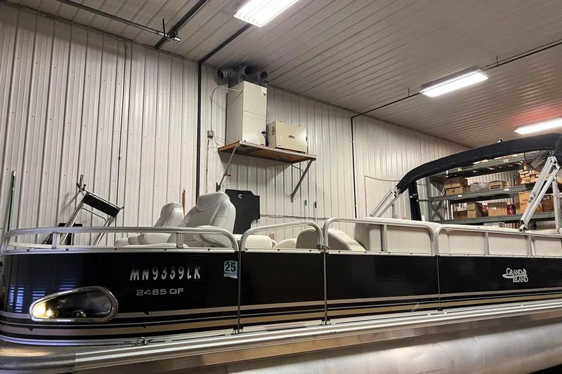 Slide: The Image of 2014 Avalon Grand Island 2485 QF pontoon boat in a storage facility. - 82