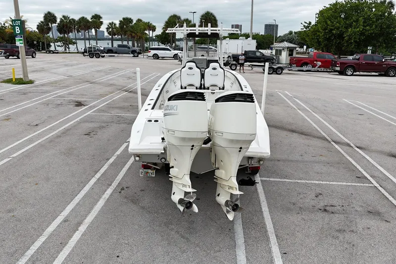 Slide: The Image of 2002 Island Runner 31 boat with dual Suzuki outboard motors in a parking lot. - 7