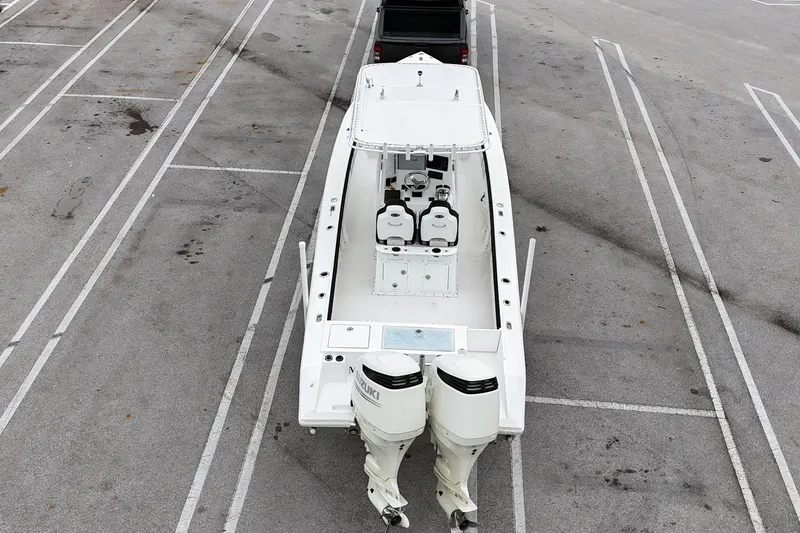 Slide: The Image of 2002 Island Runner 31 boat with dual engines in a parking lot. - 9