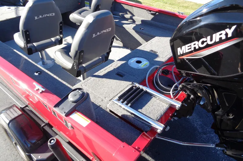 Slide: The Image of 2022 Lund 1650 Rebel XL SS boat interior with Mercury engine and seating. - 11