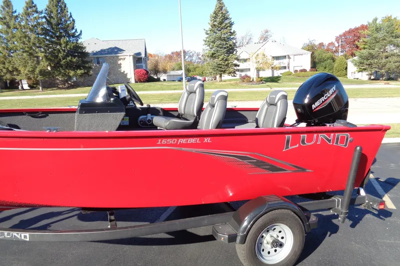 Slide: The Image of Red 2022 Lund 1650 Rebel XL SS boat with Mercury engine on trailer. - 3