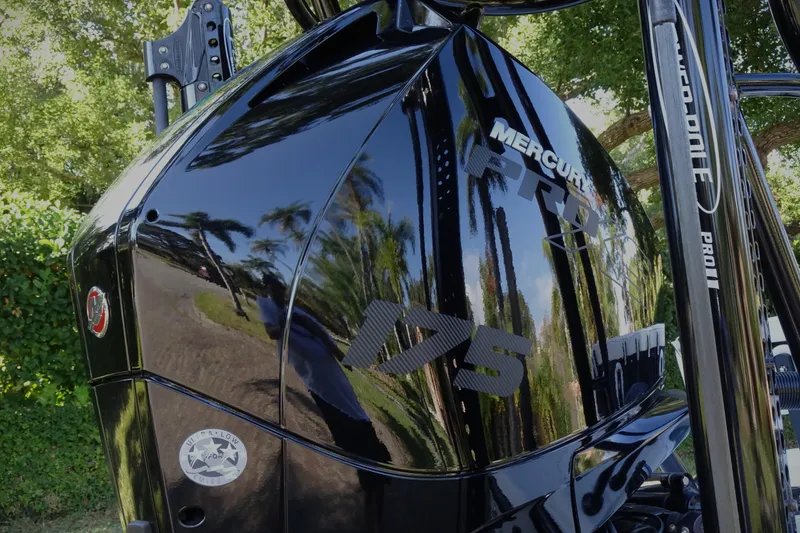 Slide: The Image of ```json "Mercury Pro XS 175 outboard motor, glossy black finish, Vtech 18, 2023 model." ``` - 10