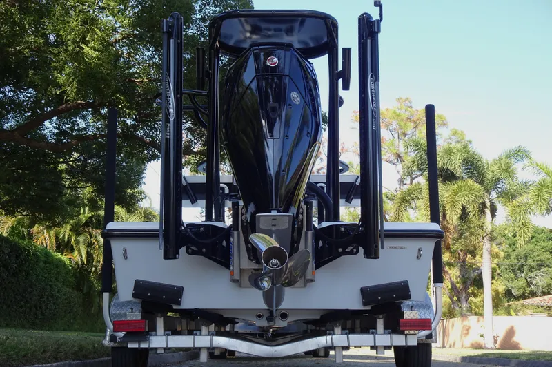 Slide: The Image of 2023 Vtech 18 boat on trailer, rear view with trees in background. - 6