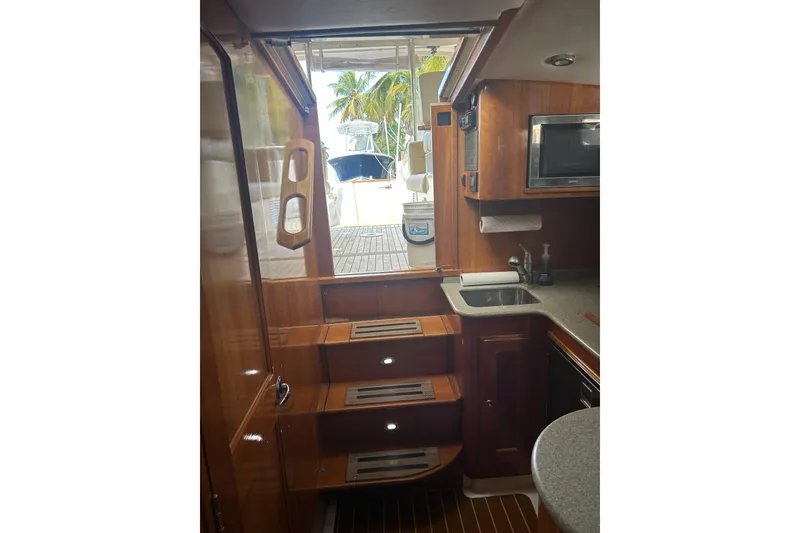 Slide: The Image of Interior of 2007 Legacy Yachts Express with kitchen and stairs. - 10