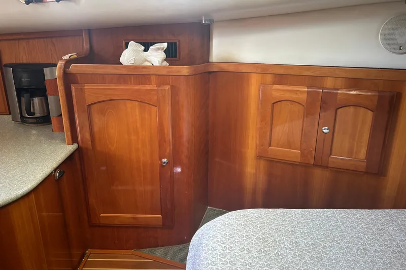 Slide: The Image of Interior of a 2007 Legacy Yachts Express with wooden cabinetry. - 17