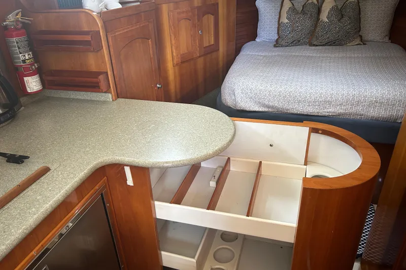 Slide: The Image of Interior of 2007 Legacy Yachts 32 Express with bed, storage, and kitchenette. - 8