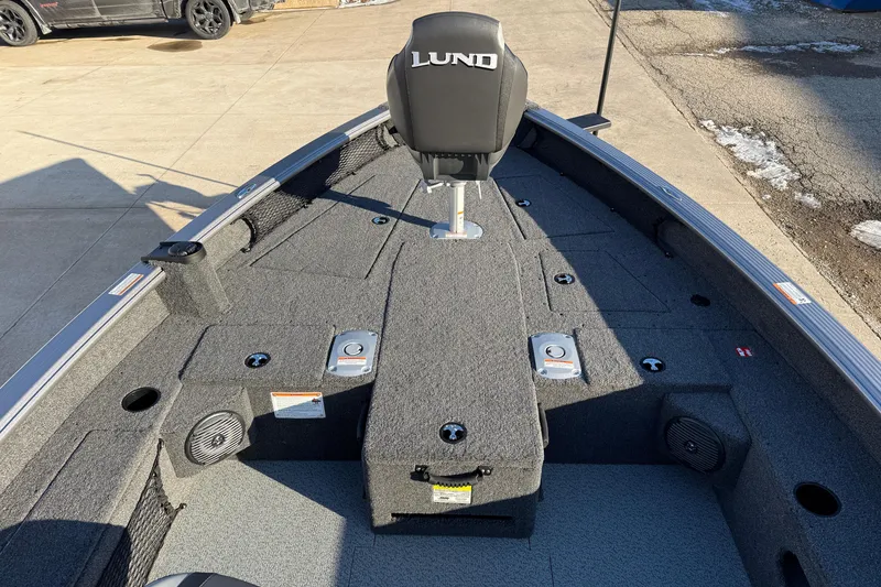Slide: The Image of 2026 Lund 1875 Pro Guide boat interior with gray carpet and seating. - 12