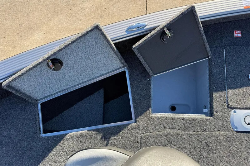 Slide: The Image of 2026 Lund 1875 Pro Guide boat storage compartments with open lids, showcasing interior space. - 15