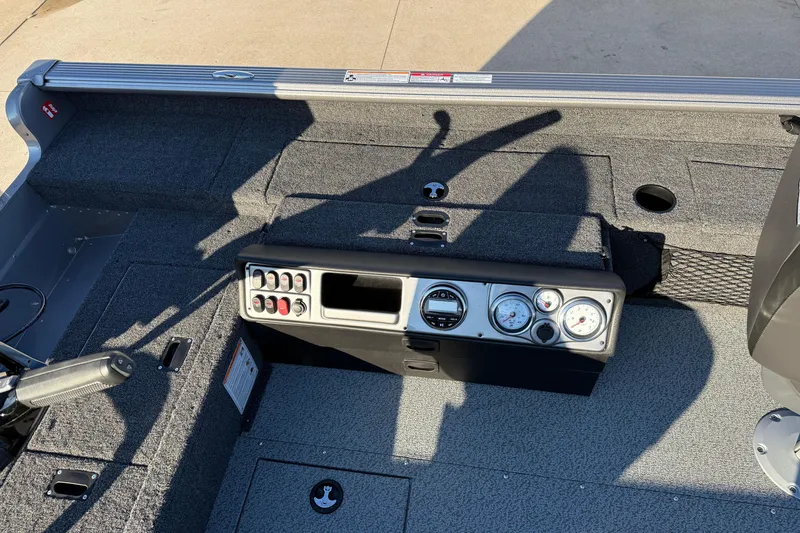 Slide: The Image of 2026 Lund 1875 Pro Guide boat dashboard with gauges and controls, featuring a sleek design. - 16