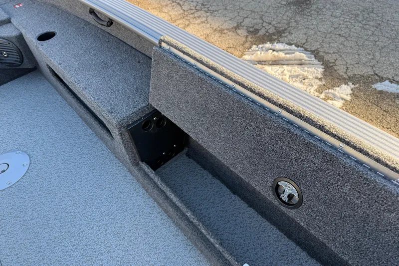 Slide: The Image of 2026 Lund 1875 Pro Guide boat interior with storage compartments and textured flooring. - 18