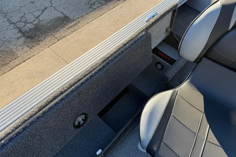 Slide: The Image of 2026 Lund 1875 Pro Guide boat interior with seating and storage compartments. - 19