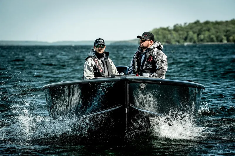 Slide: The Image of 2026 Lund 1875 Pro Guide boat on trailer outside showroom. - 3