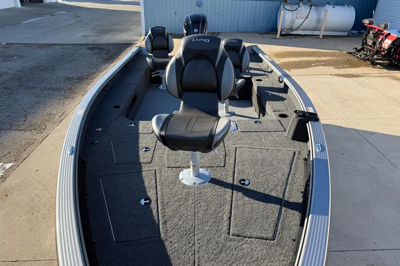 Slide: The Image of 2026 Lund 1875 Pro Guide fishing boat with seating and storage compartments. - 9