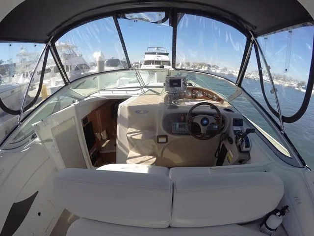 Slide: The Image of 2005 Four Winns 268 Vista boat interior with helm, steering wheel, and navigation equipment. - 10