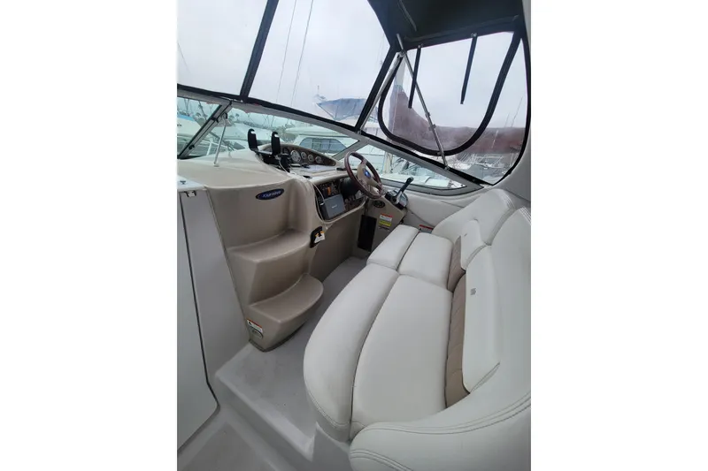Slide: The Image of Interior of 2005 Four Winns 268 Vista boat with steering wheel and seating. - 11