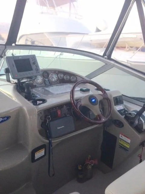 Slide: The Image of 2005 Four Winns 268 Vista boat cockpit with steering wheel and navigation equipment. - 12
