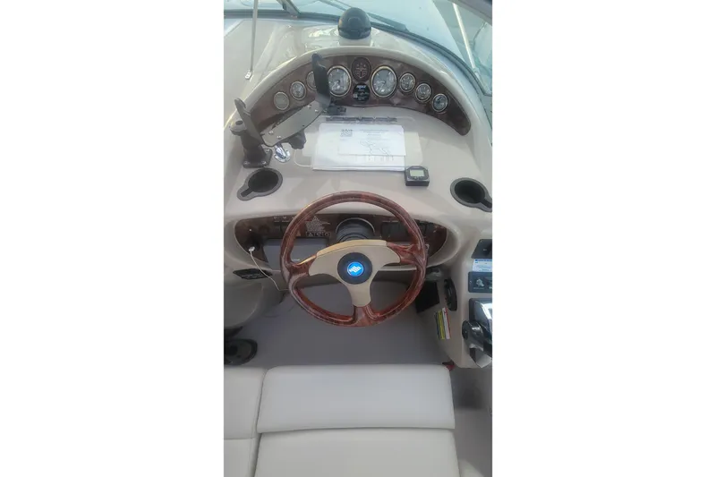 Slide: The Image of 2005 Four Winns 268 Vista boat dashboard with steering wheel and gauges. - 13