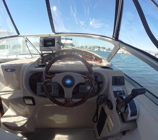 Slide: The Image of 2005 Four Winns 268 Vista boat helm with steering wheel and navigation equipment. - 14
