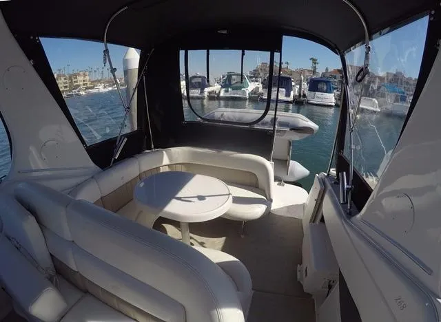 Slide: The Image of 2005 Four Winns 268 Vista boat interior with seating and table, docked at marina. - 15