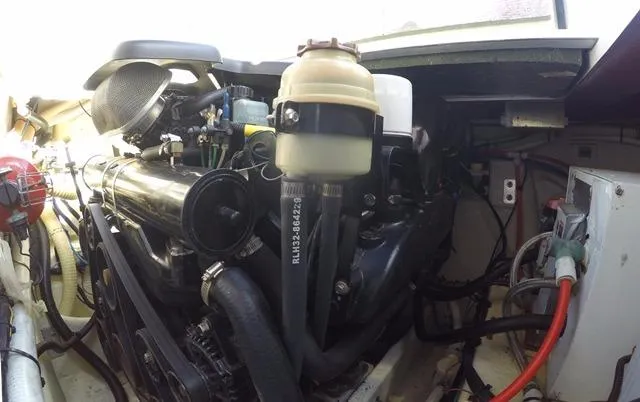 Slide: The Image of Engine compartment of a 2005 Four Winns 268 Vista boat, showcasing mechanical components. - 18