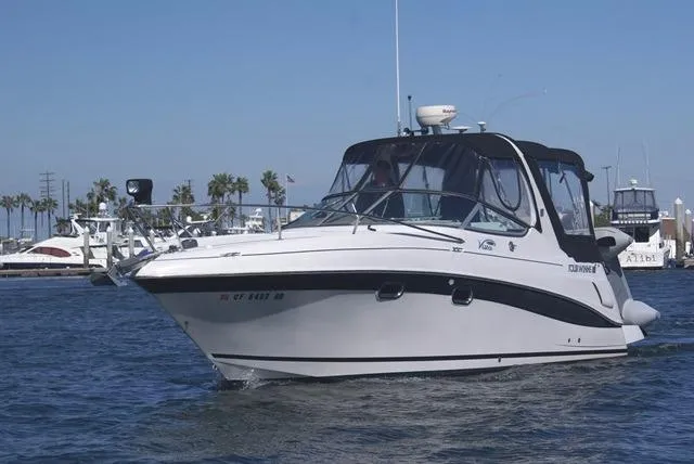 Slide: The Image of 2005 Four Winns 268 Vista boat cruising on a sunny day in a marina. - 2