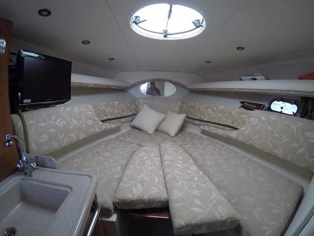 Slide: The Image of Interior of 2005 Four Winns 268 Vista boat with cozy cabin and floral upholstery. - 22