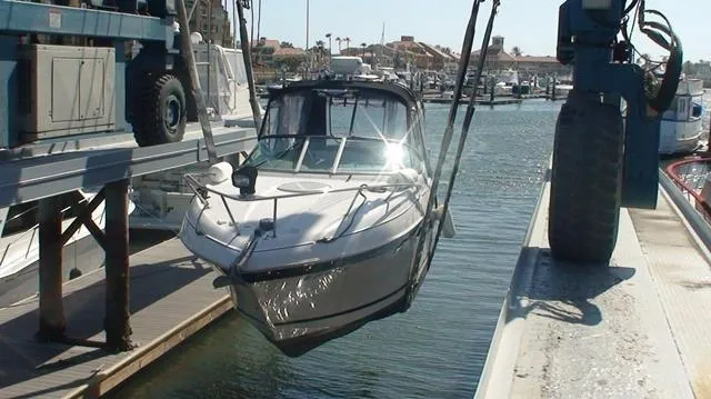 Slide: The Image of 2005 Four Winns 268 Vista boat being lifted at a marina. - 29
