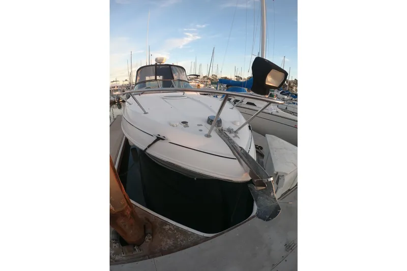 Slide: The Image of 2005 Four Winns 268 Vista boat docked at marina, clear sky background. - 5