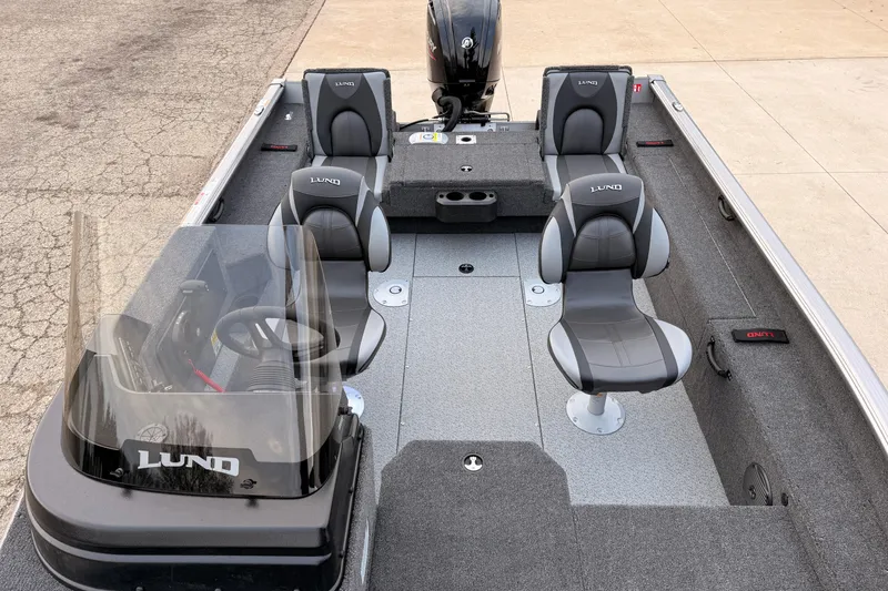 Slide: The Image of 2026 Lund 1775 Impact XS SS boat interior with seating and steering console. - 15