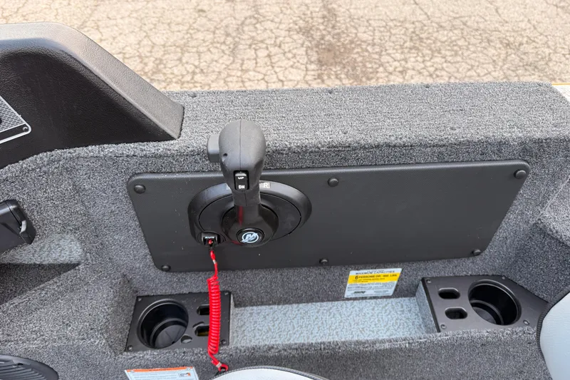 Slide: The Image of 2026 Lund 1775 Impact XS SS boat control panel with throttle lever and cup holders. - 20