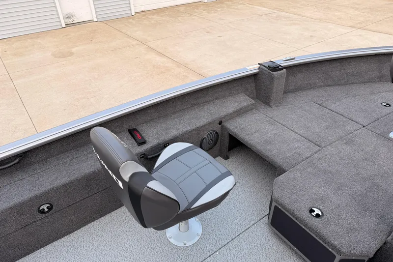 Slide: The Image of 2026 Lund 1775 Impact XS SS boat interior with gray seating and carpeted deck. - 21