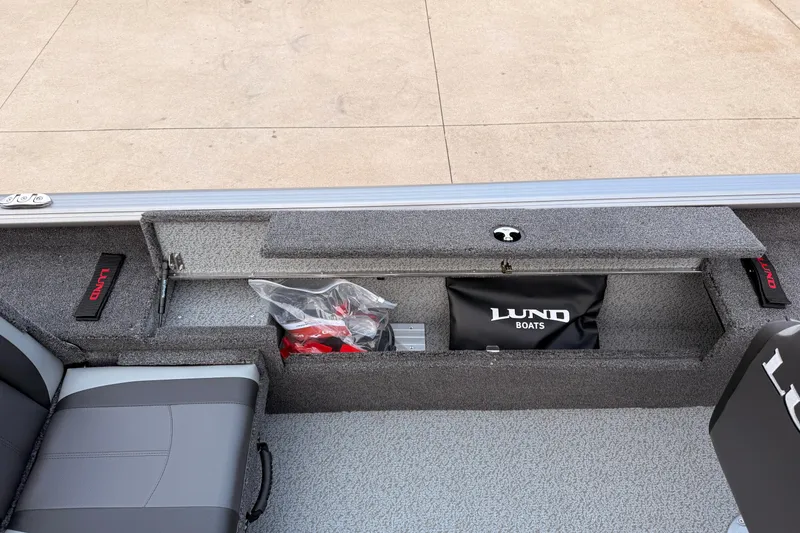 Slide: The Image of 2026 Lund 1775 Impact XS SS boat interior with storage compartments and seating. - 23